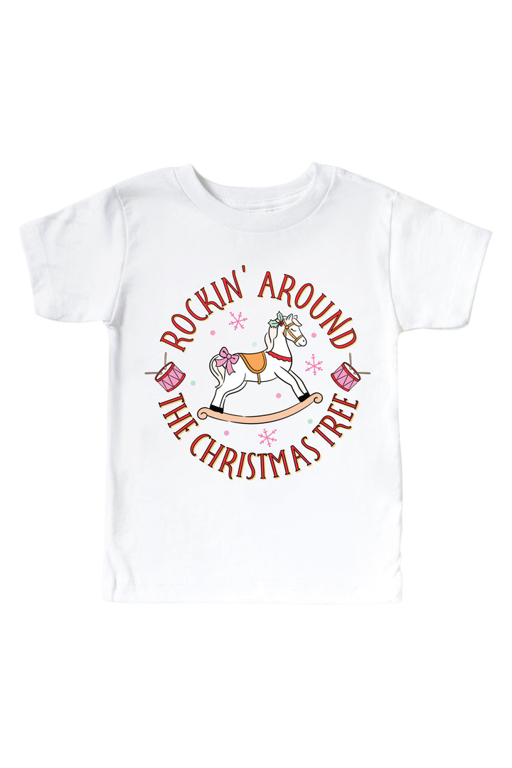 Caden Lane's white "Rockin' Around the Christmas Tree" toddler t-shirt featuring a pink rocking horse with drums and snowflakes, laid flat.
