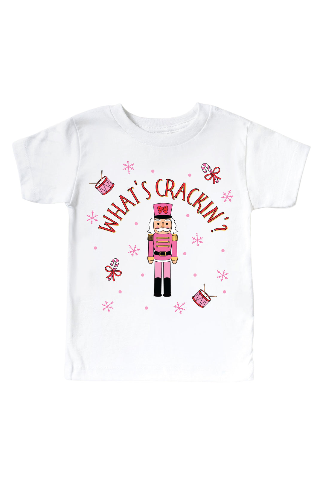 Caden Lane's white "What's Crackin'" toddler t-shirt featuring a pink toy soldier nutcracker with snowflakes, candy canes, and drums, laid flat.
