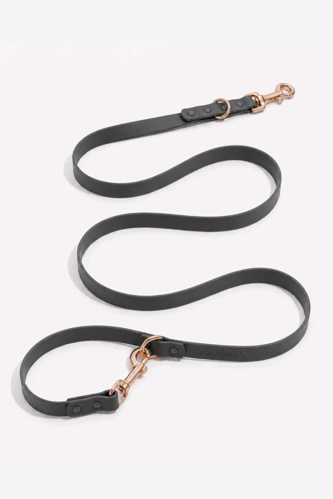 Waterproof silicone dog leash in charcoal gray, showing full length with rose gold snap hook clasp and loop handle