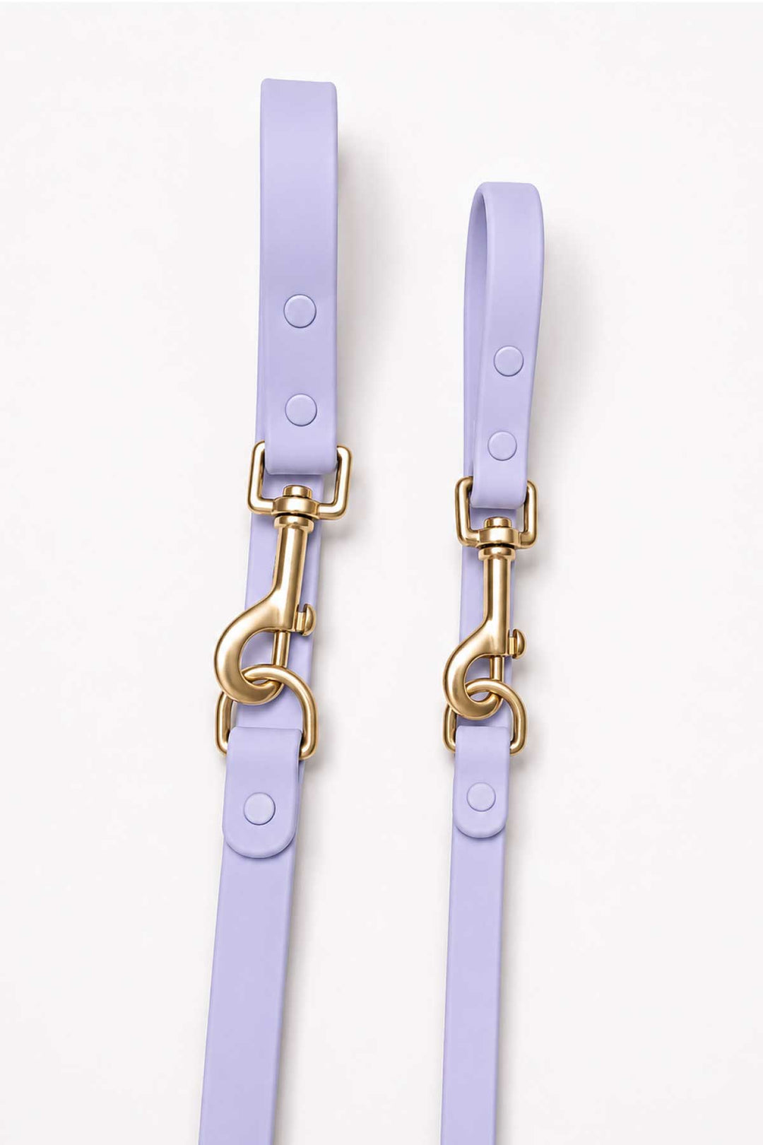 Close-up of lilac haze waterproof dog leash showing two gold snap hook clasps and leash straps side by side