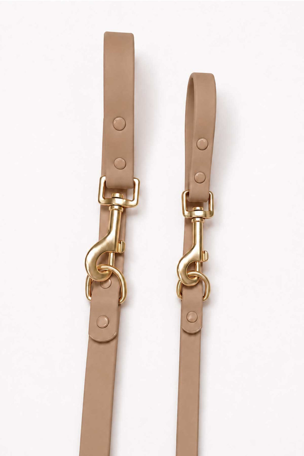 Close-up of mocha waterproof dog leash showing two gold snap hook clasps and leash straps side by side