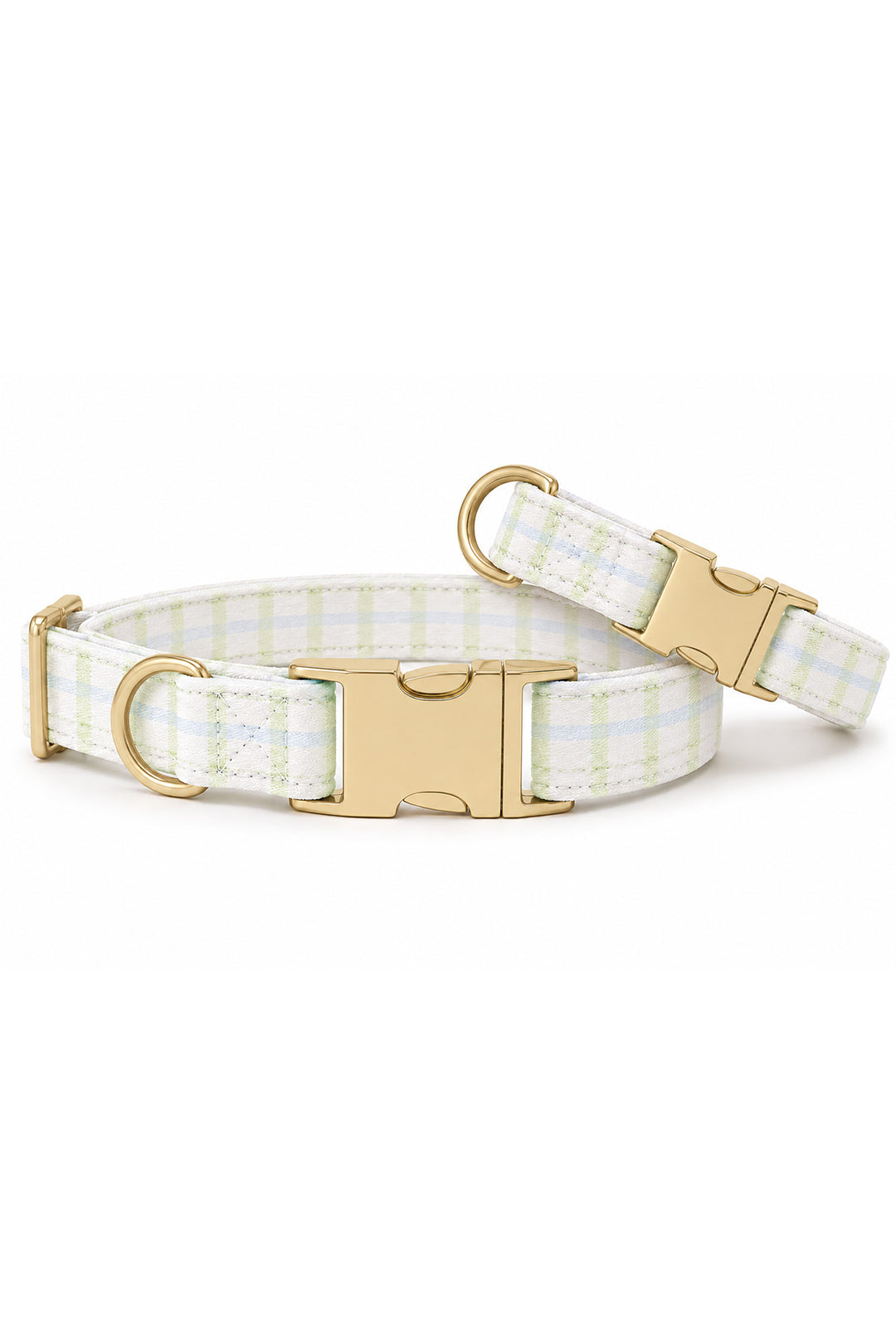 Tan French Bulldog seated and looking to the left, wearing a picnic plaid dog collar with gold personalized ID tag