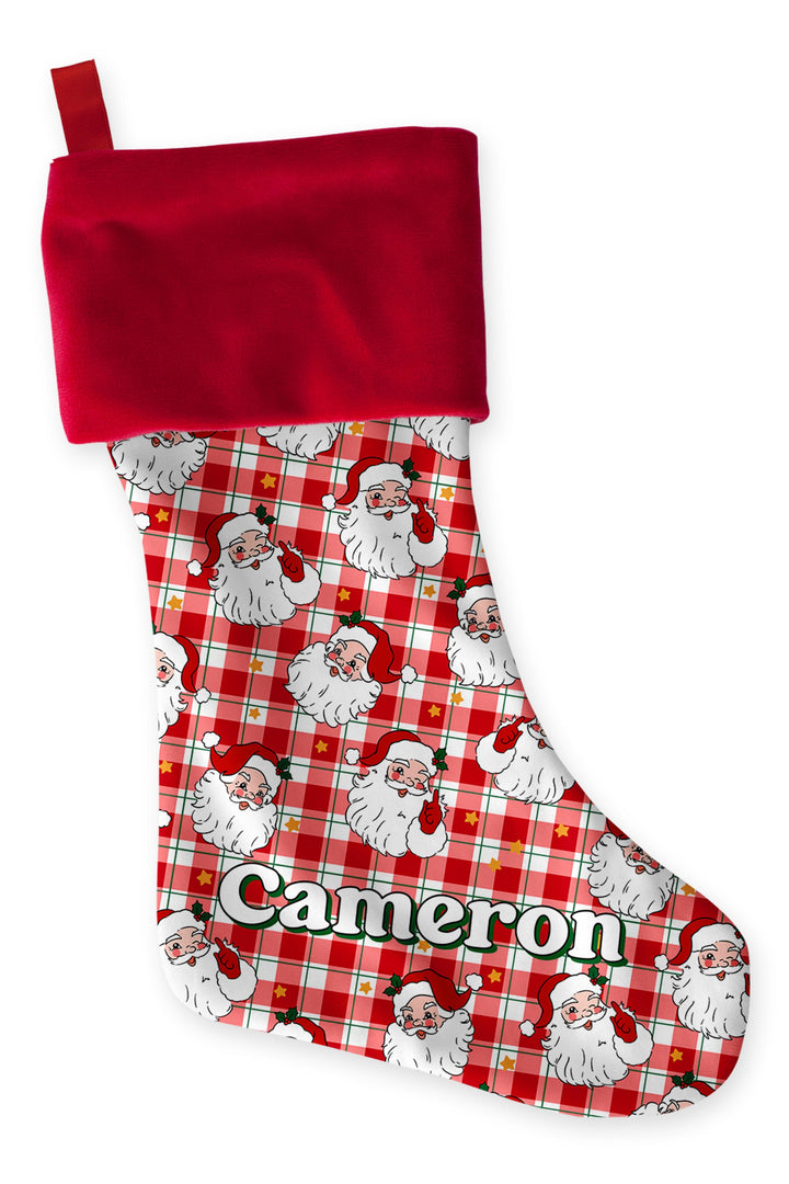 Personalized Caden Lane Cozy Claus Christmas stocking featuring a vintage Santa plaid print, plush red cuff, custom name embroidery, and matching family holiday décor.