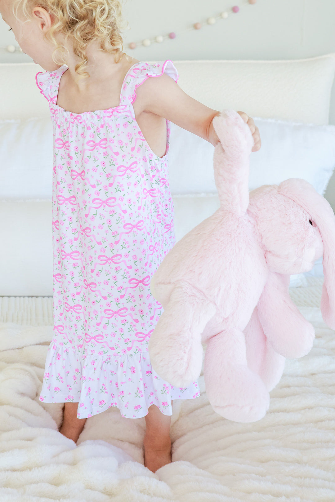Young girl smiling wearing Full Length Ruffle Nightgown in Dreamy Bows pink bow print with floral accents
