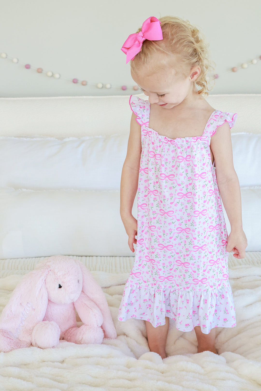 Young girl wearing Full Length Ruffle Nightgown in Dreamy Bows pink bow and floral print, smiling, full length view