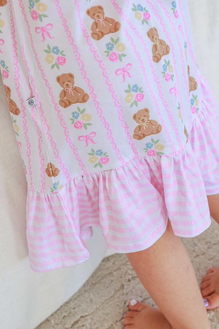 Close-up detail of Full Length Ruffle Nightgown in Beary Lovely print showing teddy bear, bow and floral fabric pattern with pink gingham ruffle hem