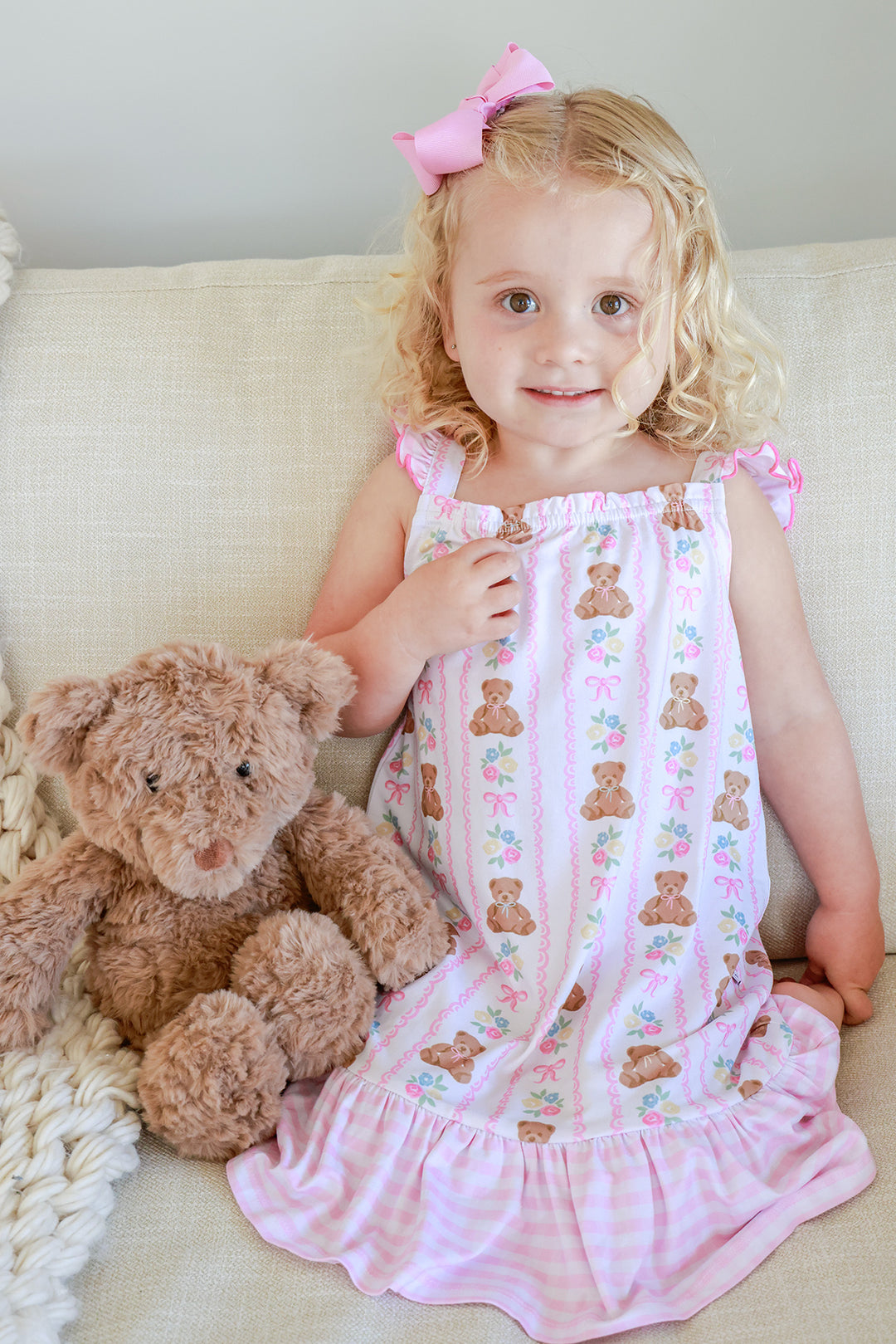Young girl sitting with teddy bear stuffed animal wearing Full Length Ruffle Nightgown in Beary Lovely print with teddy bear and floral pattern