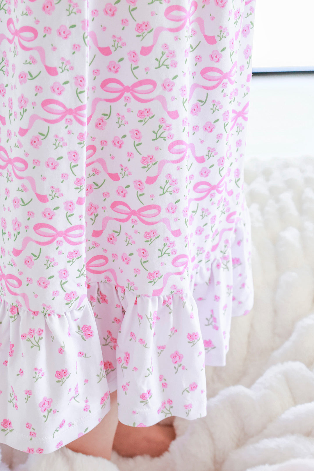 Young girl wearing Full Length Ruffle Nightgown in Dreamy Bows pink bow print, full front view with ruffle hem detail