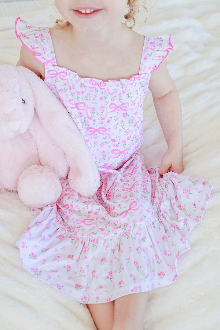 Young girl wearing Full Length Ruffle Nightgown in Dreamy Bows print, cheerful expression, full body standing pose