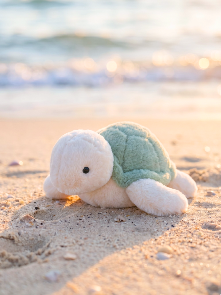 large cuddle plush sea turtle stuffed animal at the beach — summer ocean toy for kids