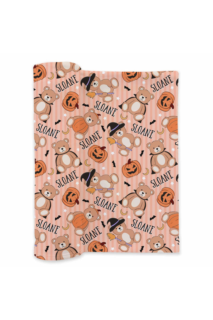 Caden Lane patterned swaddle with teddy bears and pumpkins on an orange background