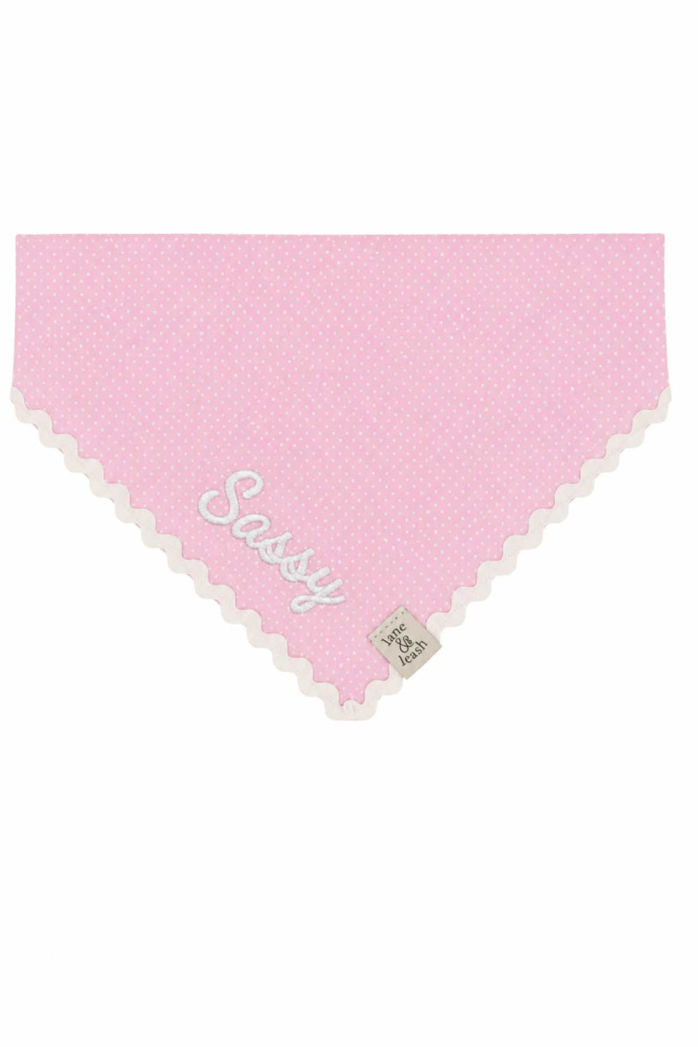 Pink polka dot pet bandana with white ric-rac lace trim, embroidered with the name Sassy in white script lettering