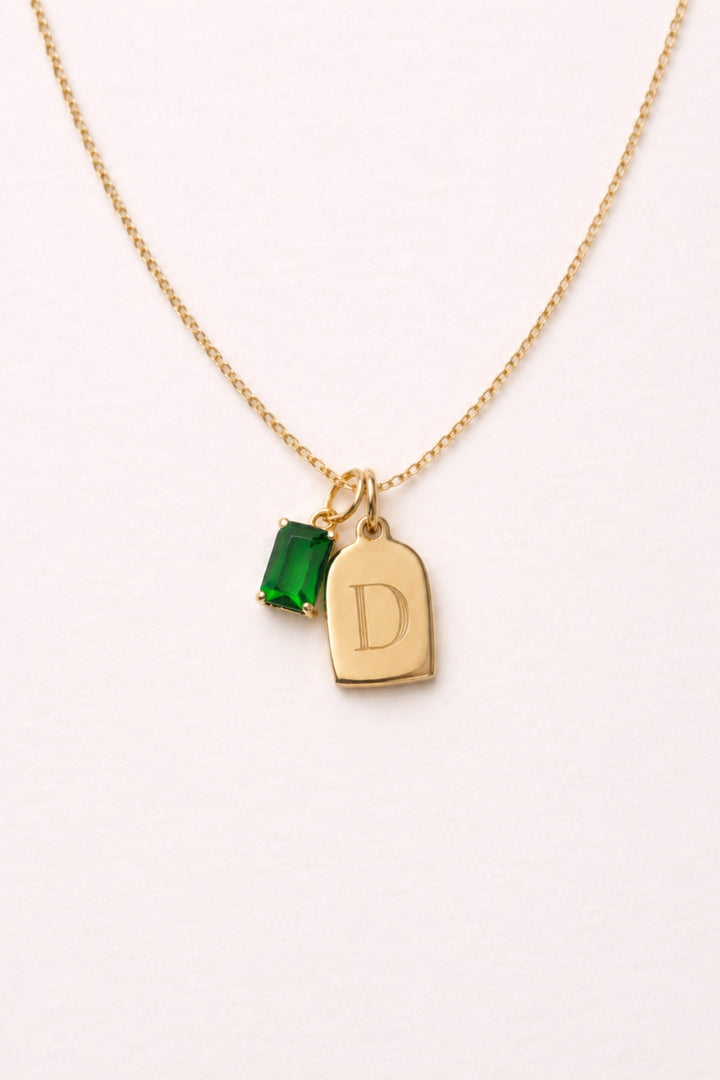 Caden Lane gold necklace with engraved initial "D" tag charm and green birthstone charm