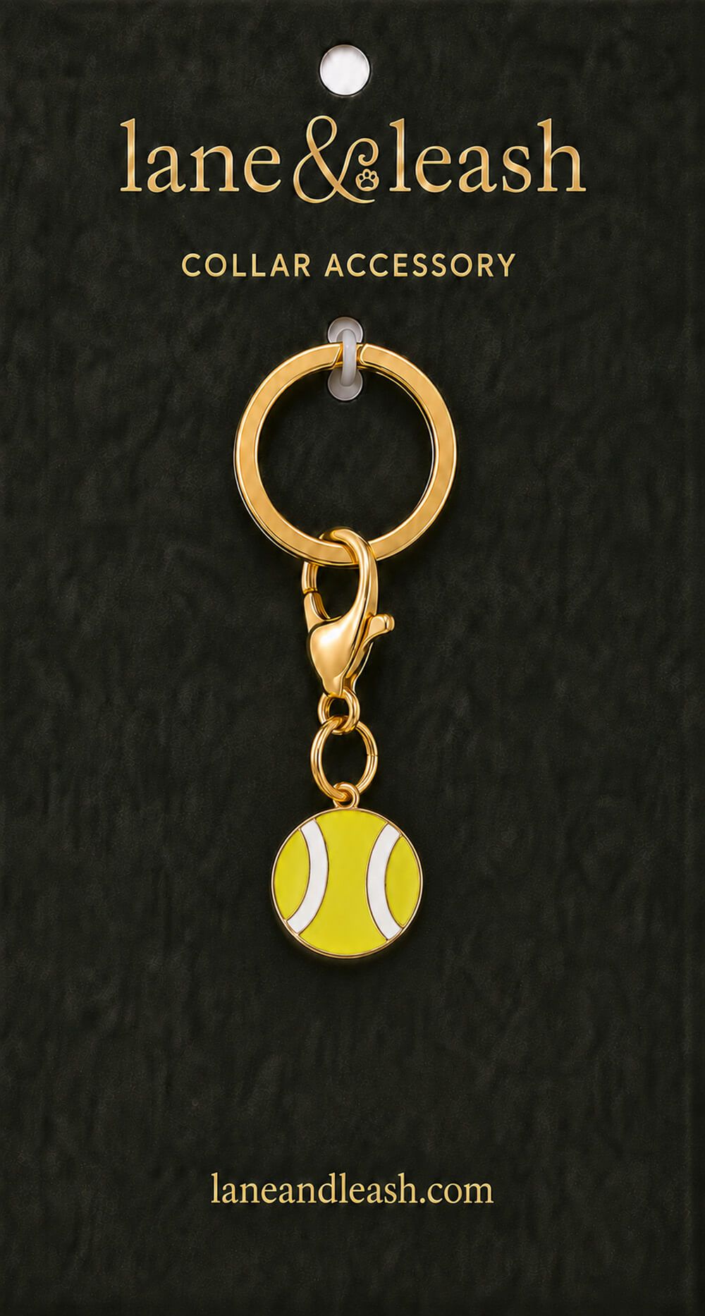 Yellow tennis ball Lane & Leash collar accessory charm displayed on dark green packaging card with lobster claw clasp and jump ring