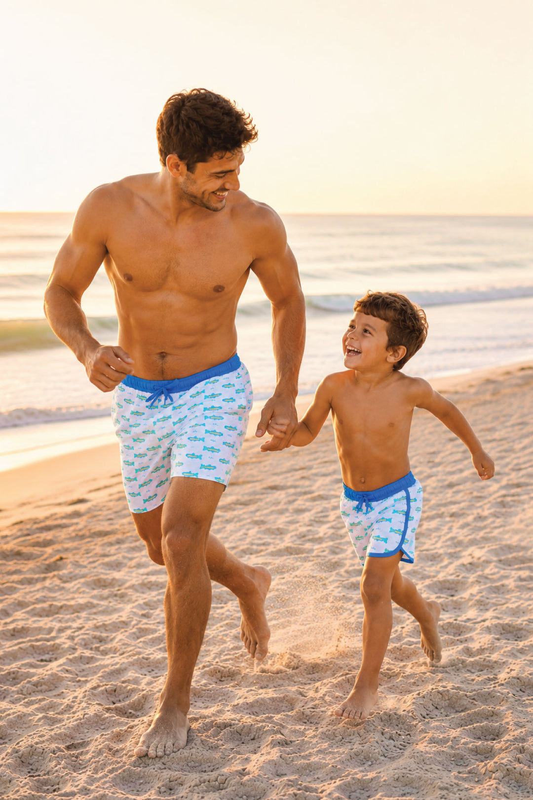 dad and son running on the beach in matching trout swim trunks 