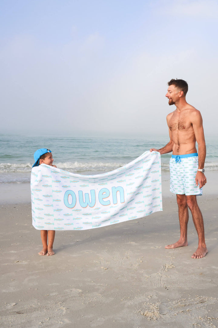 dad and son holding up trout personalized beach towel 