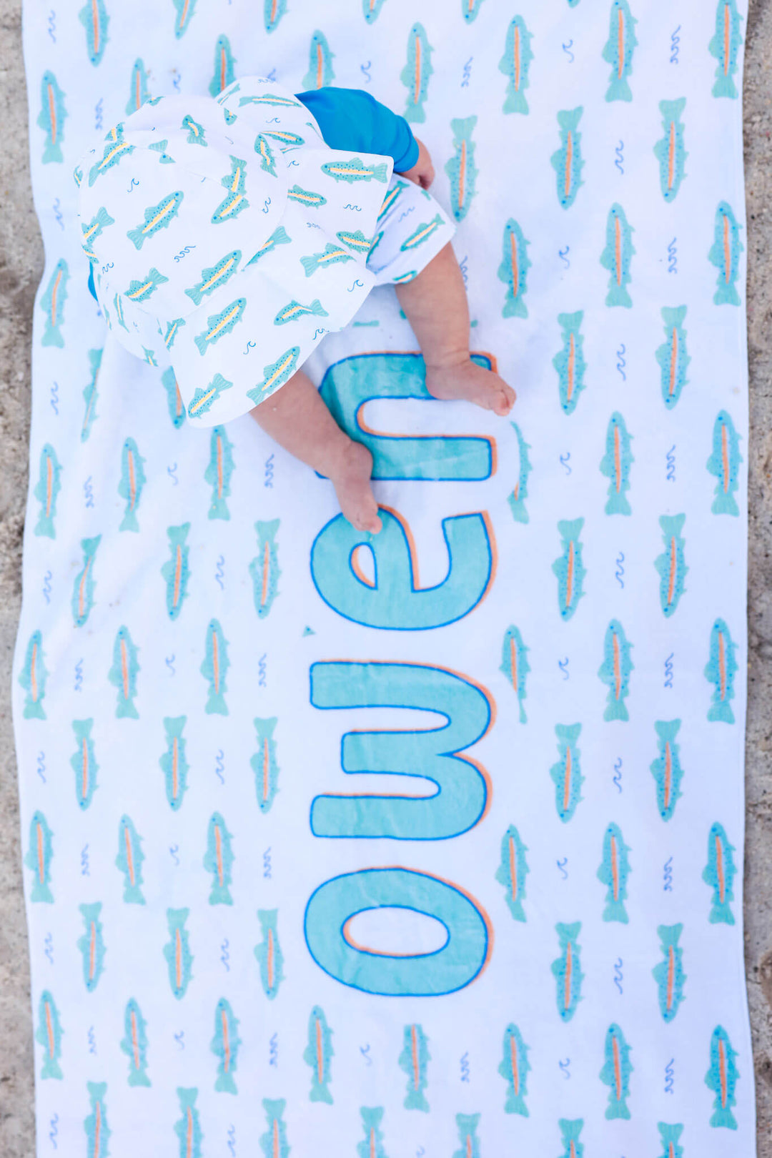 baby sitting on trout personalized beach towel