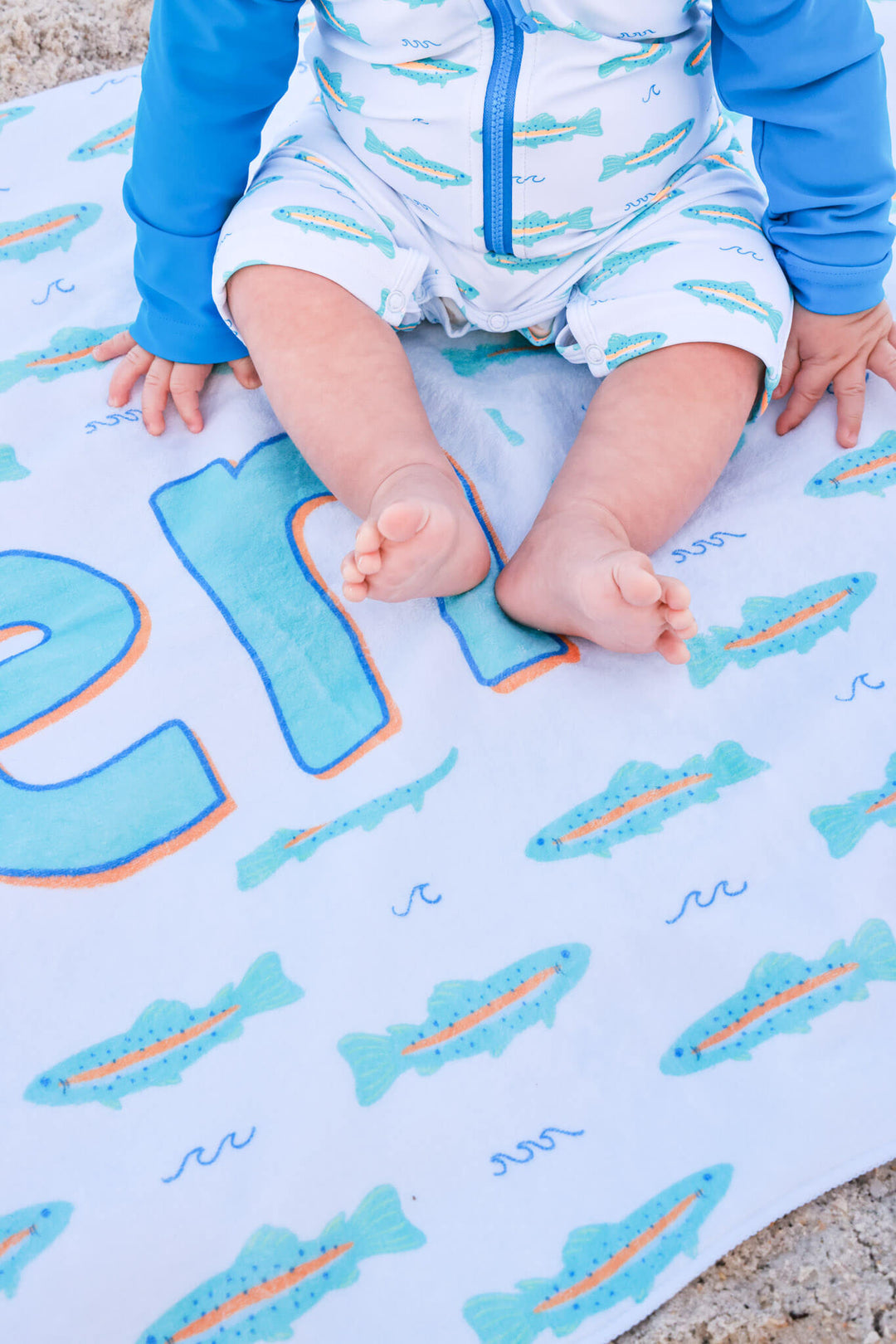 closeup of tiny trout personalized beach towel for boys 