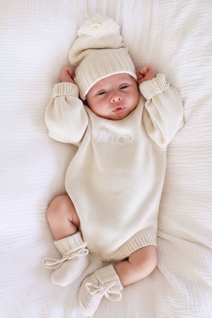 light tan embroidered knit sweater romper for babies with matching beanie and booties 