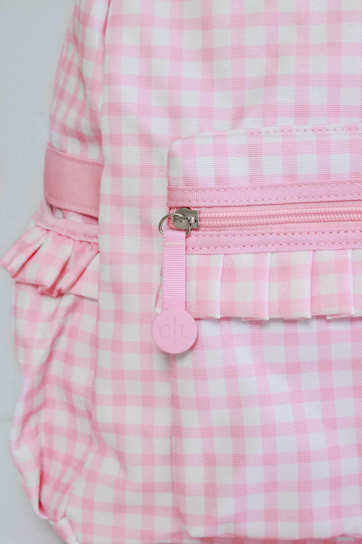 closeup of zipper on pink gingham embroidered backpack 