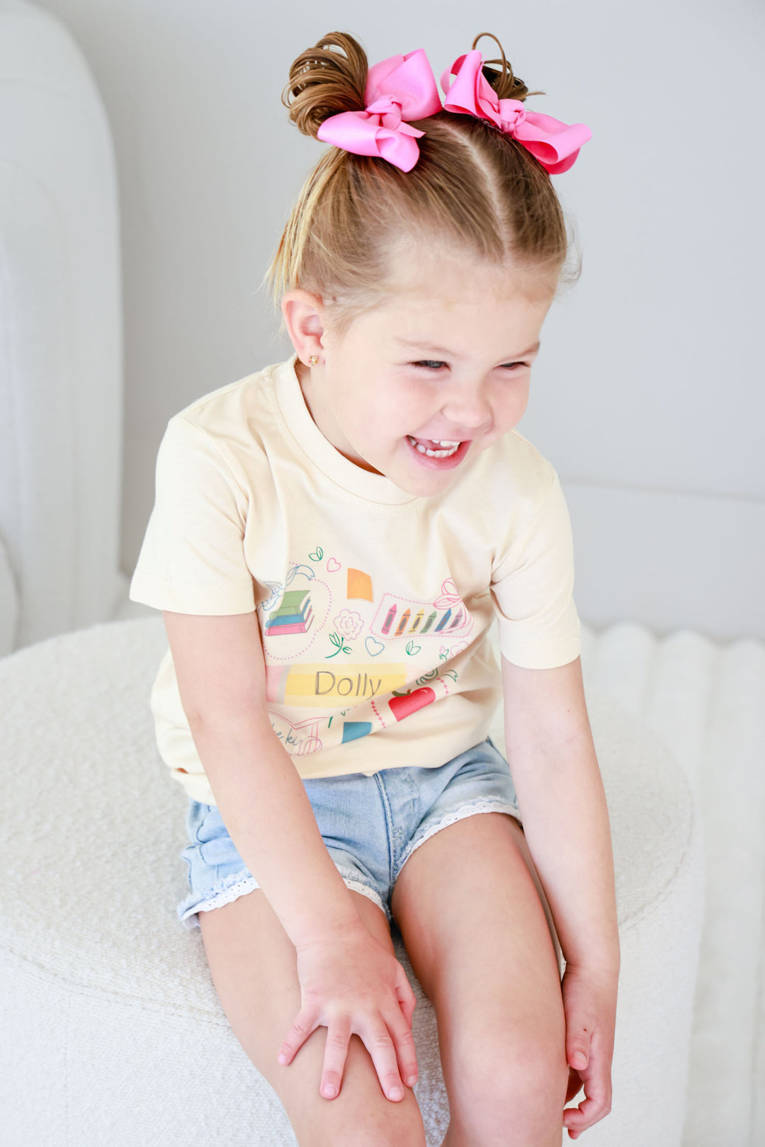 girl laughing wearing a girly back-to-school t-shirt personalized with name 