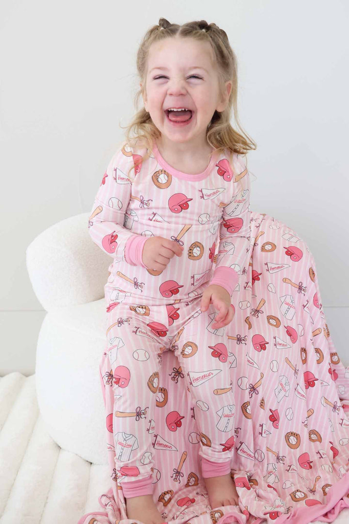 laughing girl in pink stripes girly baseball themed two piece bamboo pajama set 