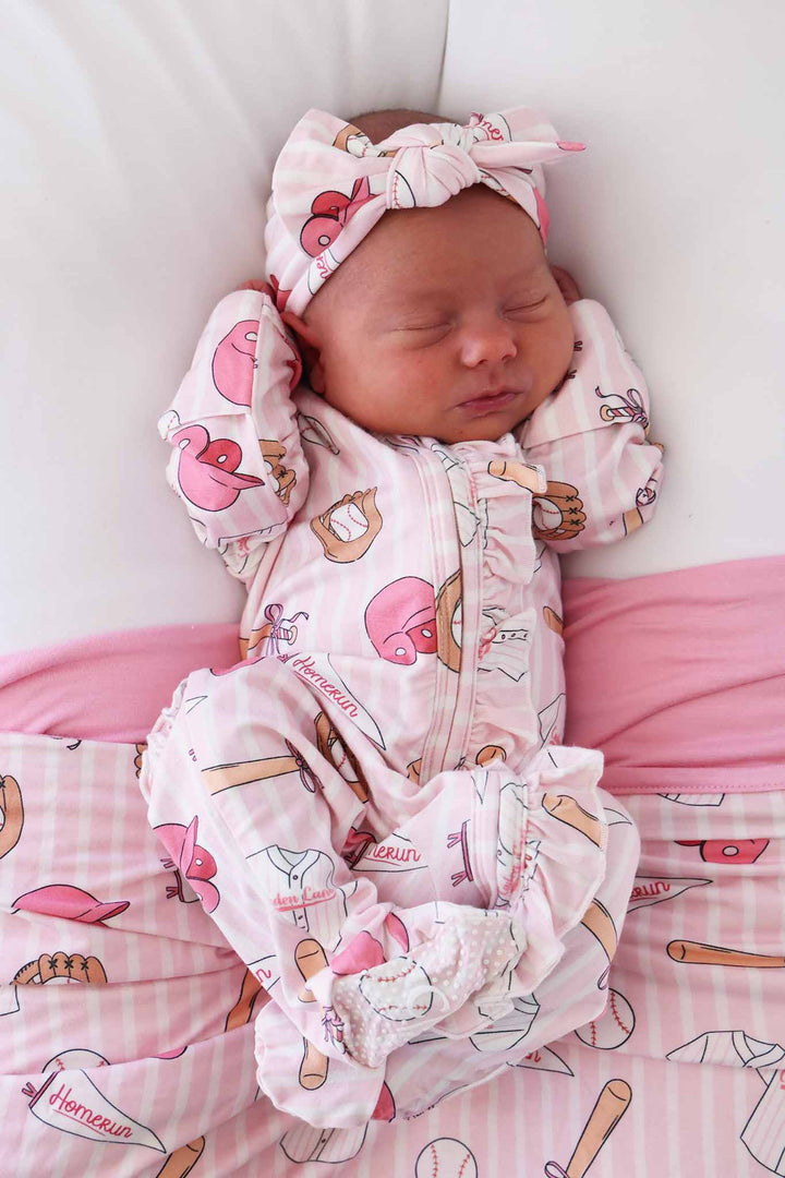 pink ruffle zipper footie for girls in ballpark babes with matching headwrap and bamboo blanket 