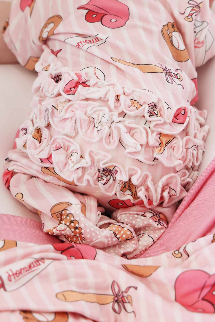 back view of ruffle bottom zipper footie for girls in pink ballpark babes print 