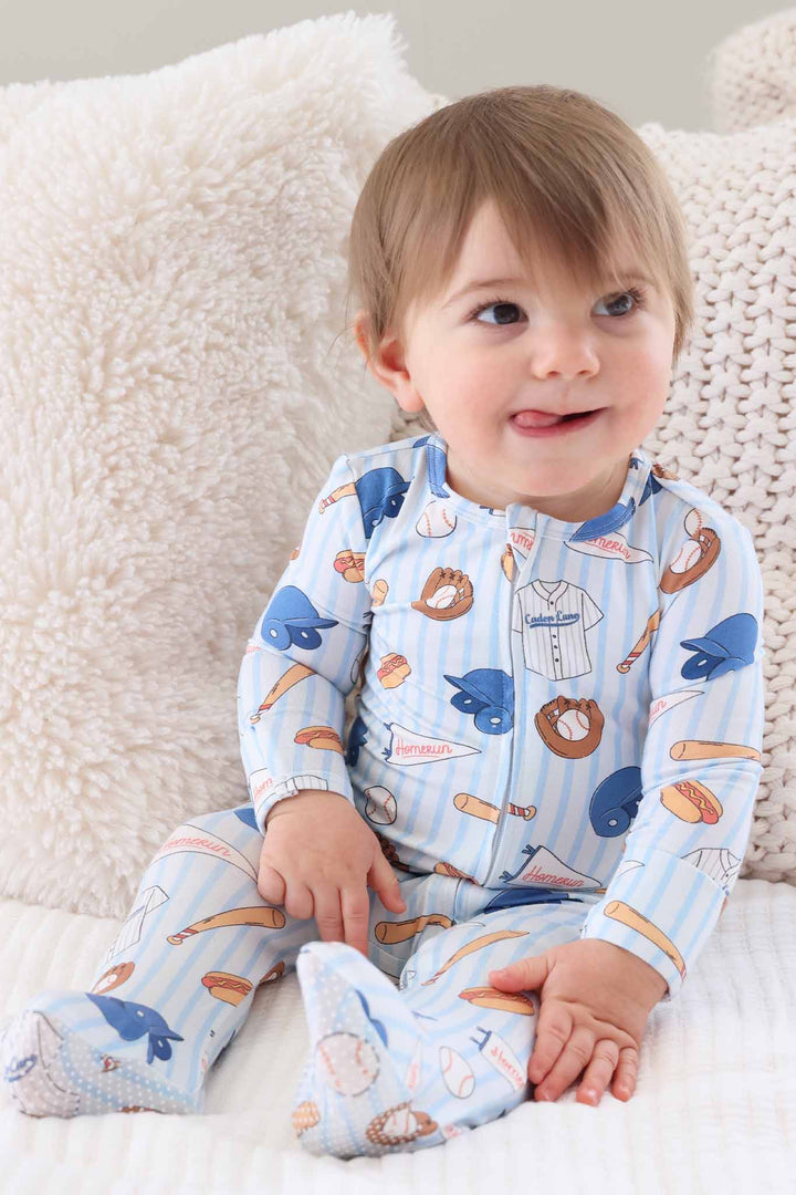 baby boy with tongue sticking out in baseball bros bamboo zipper footie 