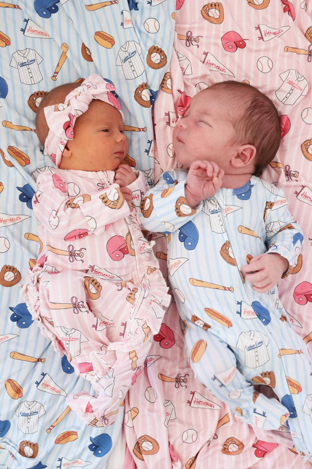 boy/girl twins in matching footie pajamas baseball themed 