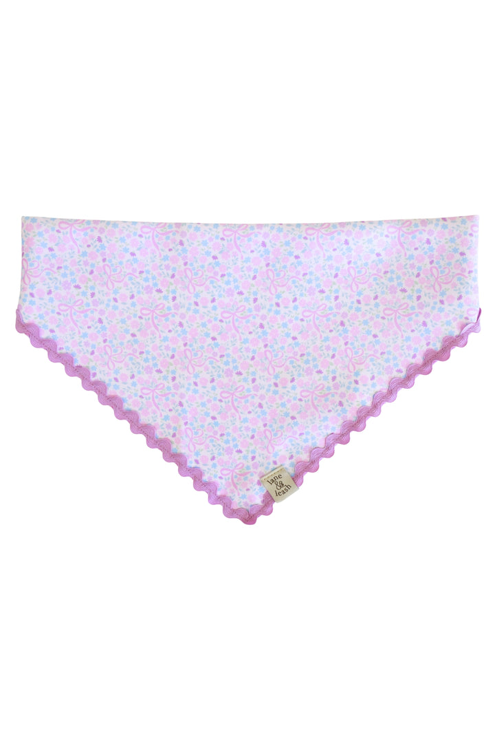 Embroidered pet bandana in the Ribbon Garden print — soft pink and lavender floral fabric with a purple scalloped embroidered edge — displayed flat in a triangle shape without personalization
