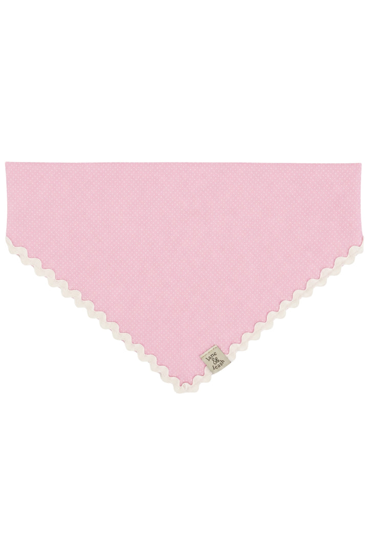 Pink polka dot pet bandana laid flat in a triangle shape with white ric-rac lace trim along the edges