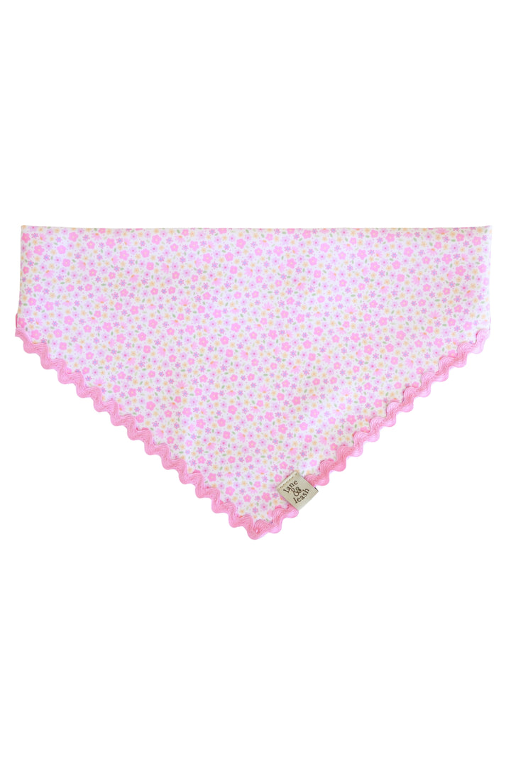 Flat lay of Scattered Blooms pet bandana with pink ditsy floral print and pink ric-rac edge trim, without personalization