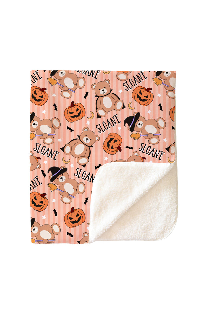 Caden Lane Halloween-themed blanket with teddy bears and pumpkins on an orange background