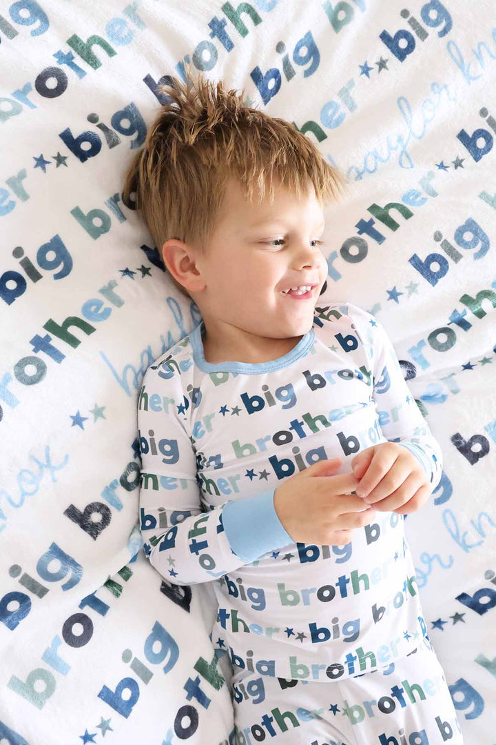 boy with matching big brother personalized kids blanket and pajamas