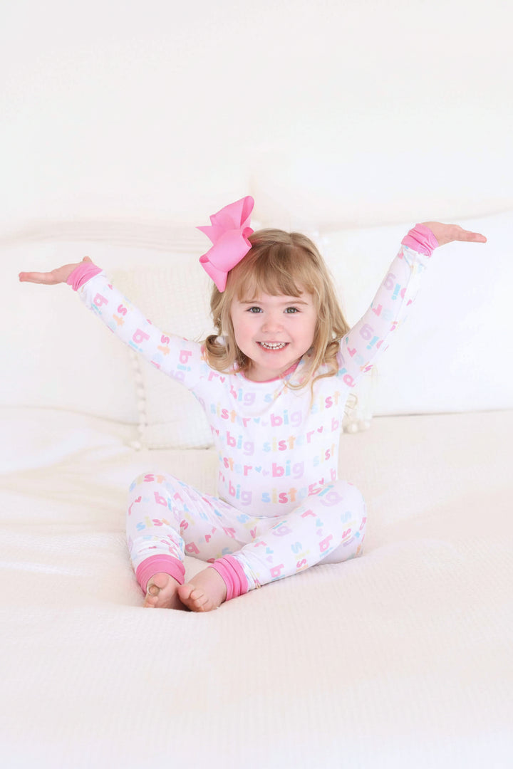 girl wearing big sister two-piece pajama set