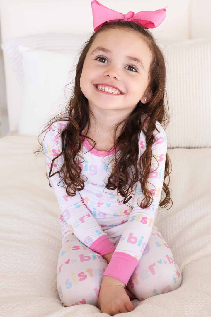 girl wearing big sister two-piece pajama set