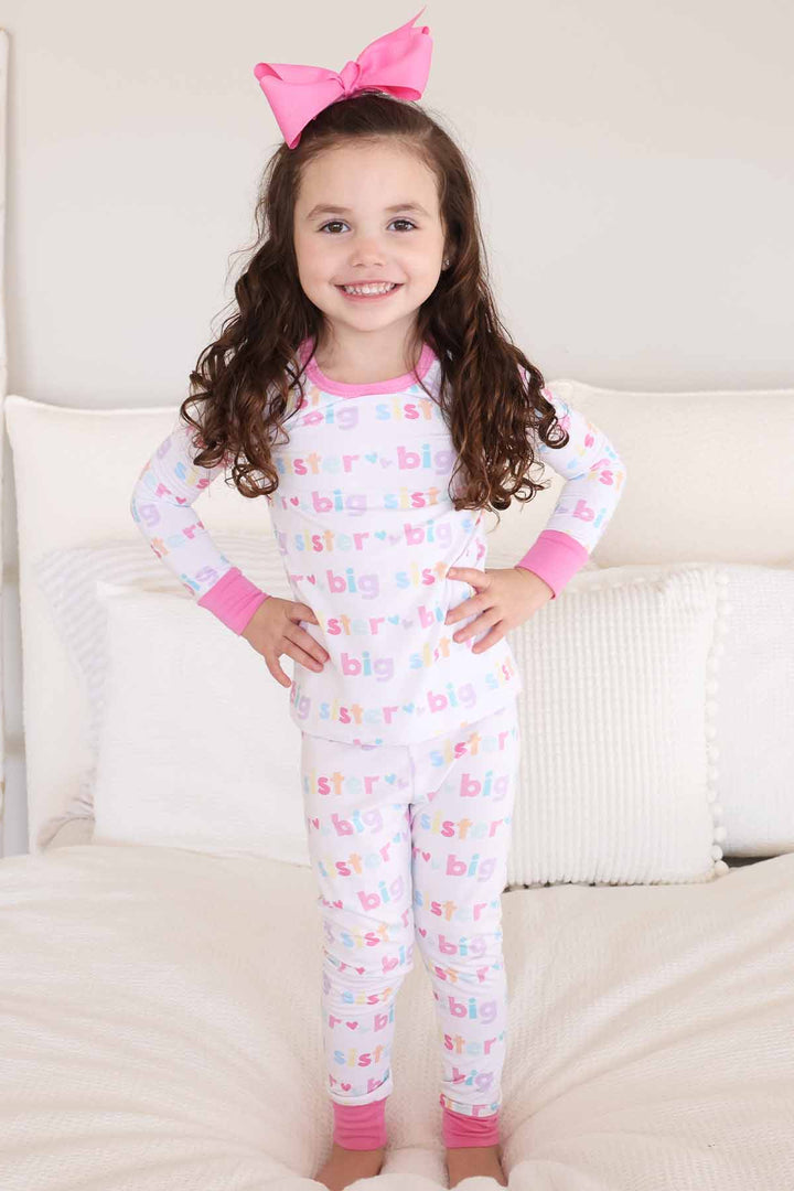 girl wearing big sister two-piece pajama set
