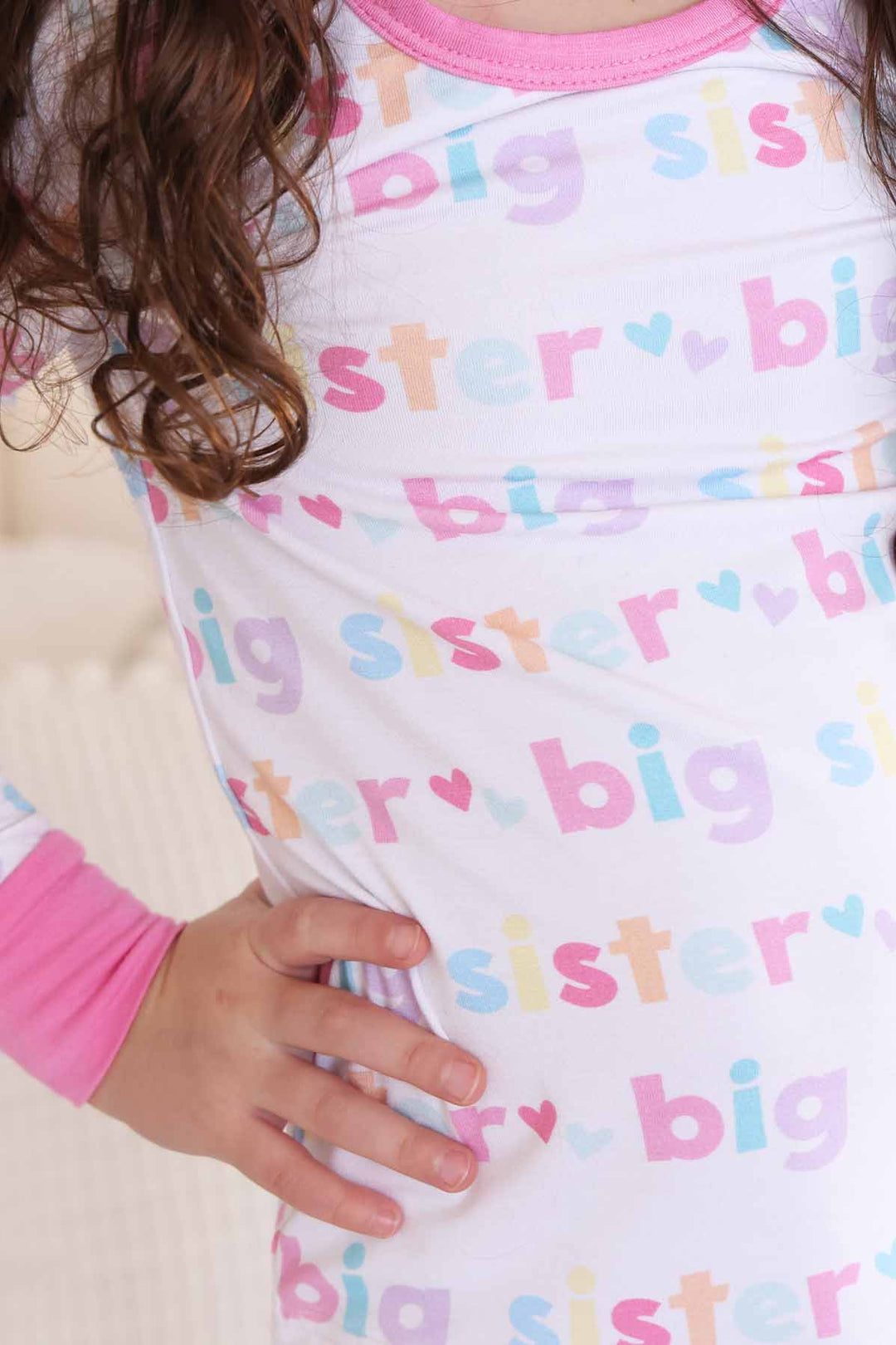 girl wearing big sister two-piece pajama set