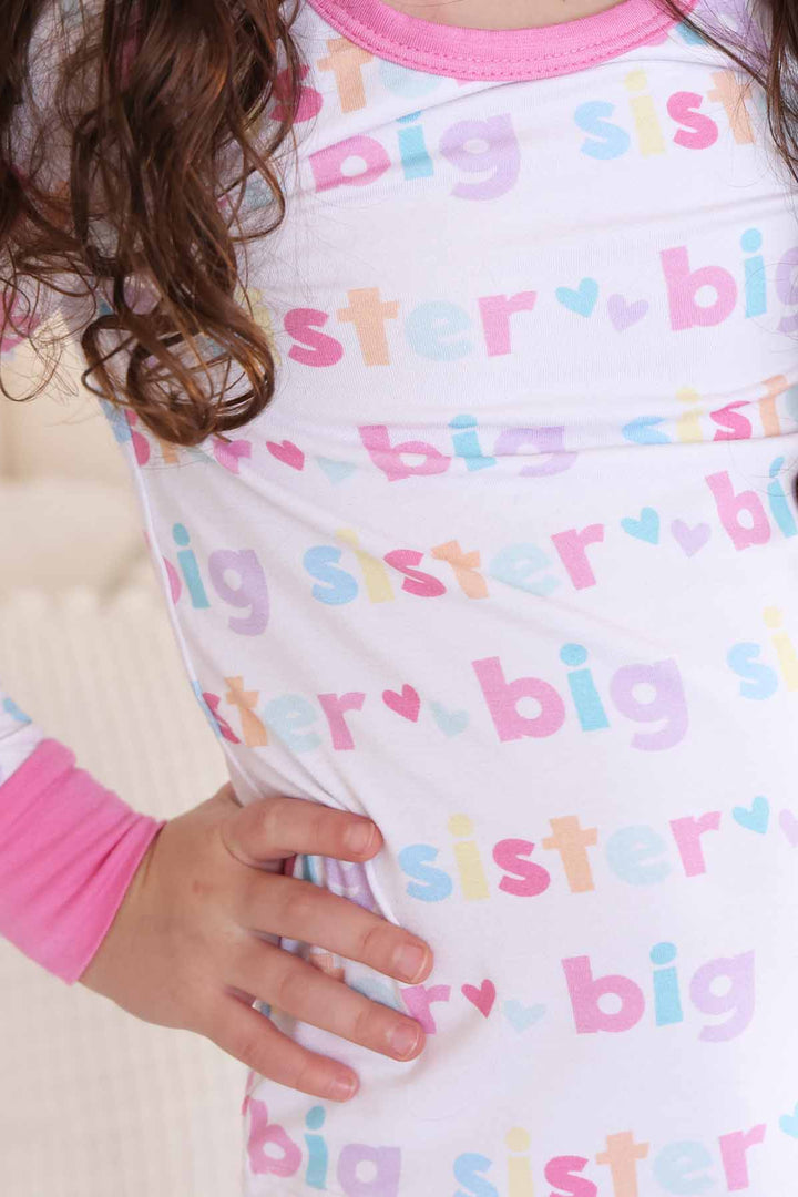 girl wearing big sister two-piece pajama set