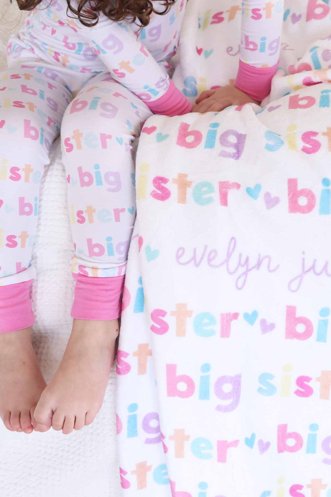 girl with matching big sister personalized kids blanket and pajamas