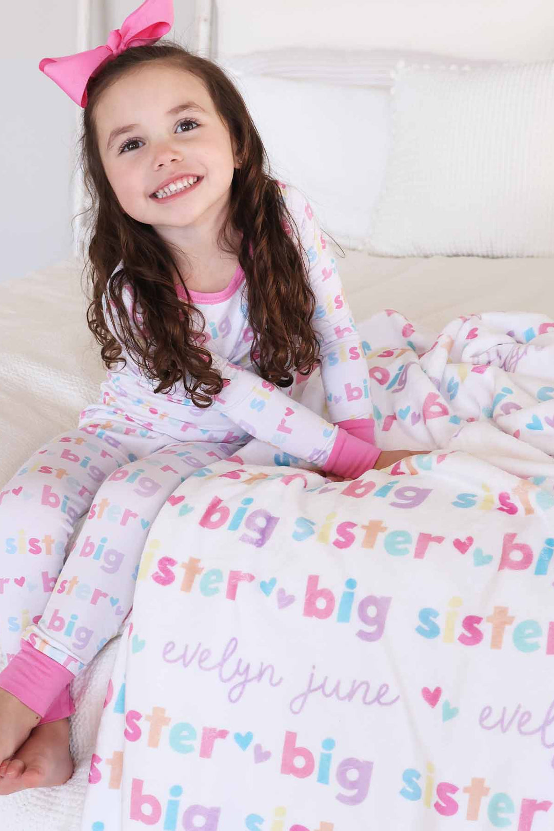 girl with matching big sister personalized kids blanket and pajamas