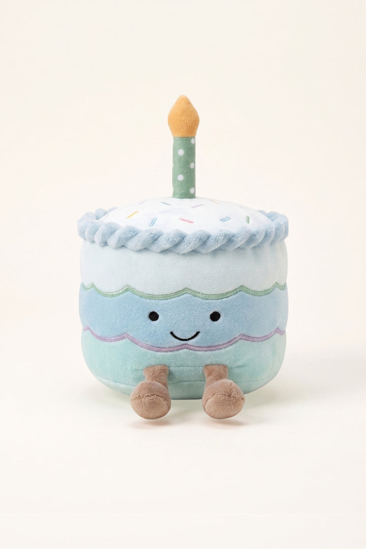 Caden Lane birthday cake cuddle plush friend in blue with white and blue frosting, and a green spotted candle 
