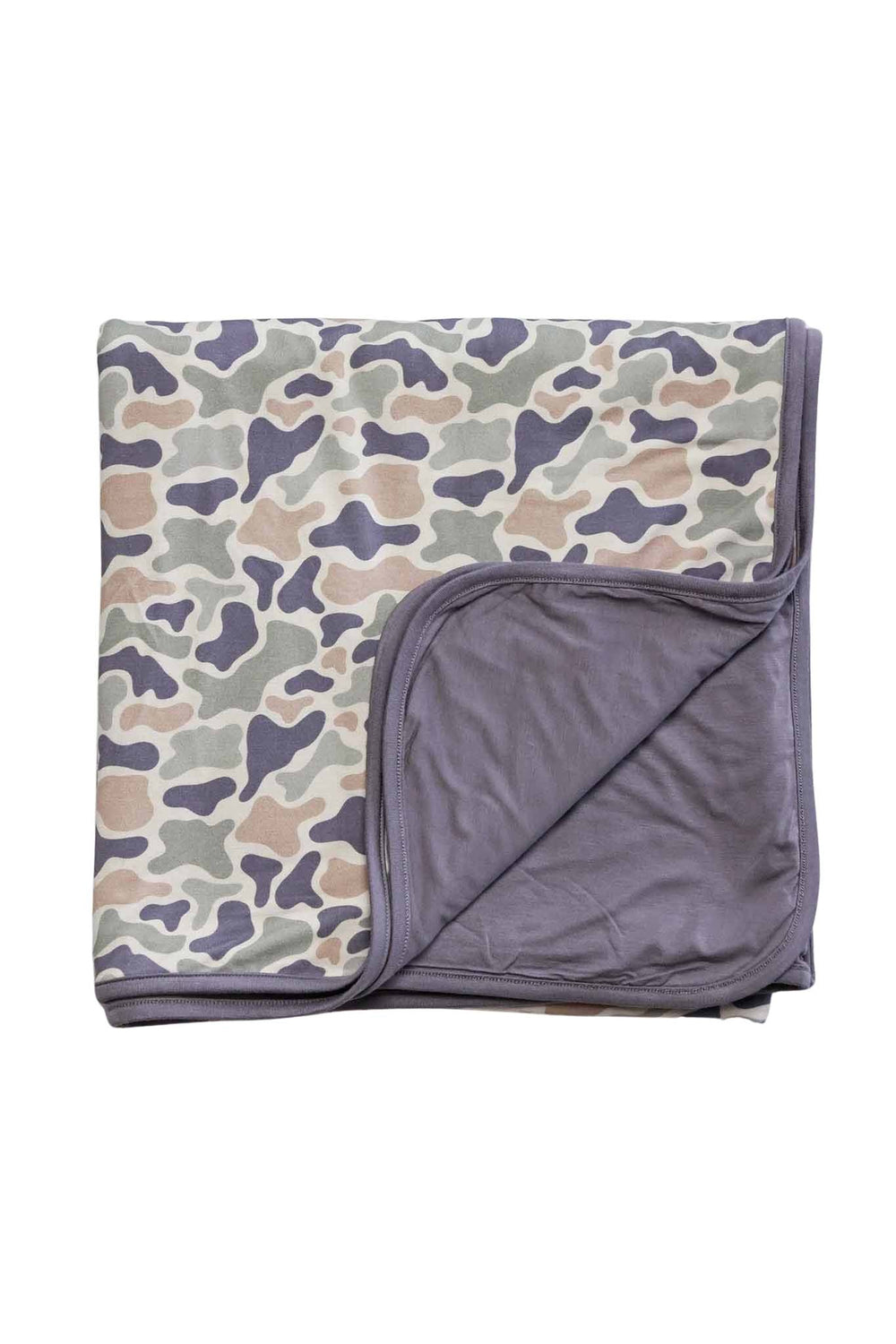Double-sided bamboo blanket folded flat with corner turned back showing camo cutie print exterior and solid lavender gray interior