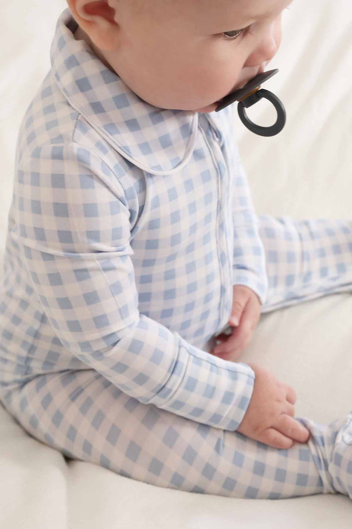 newborn wearing light blue gingham footie