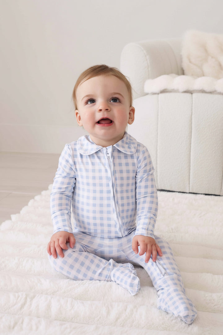 baby wearing light blue gingham footie with peter pan collar