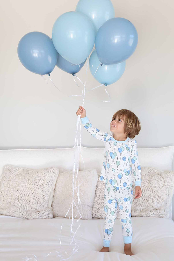 boy in birthday-themed two piece pajama set 