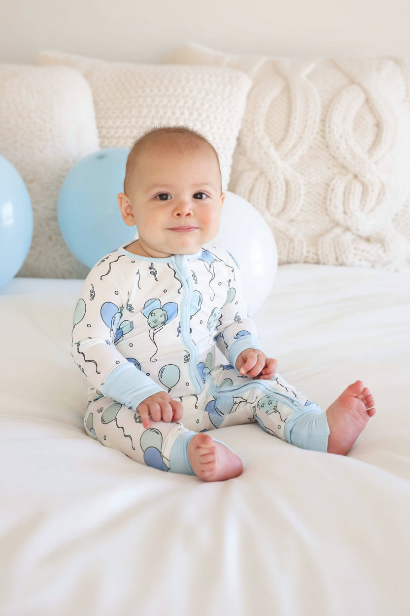 boy wearing blue and green balloon bamboo long sleeve convertible zip romper 