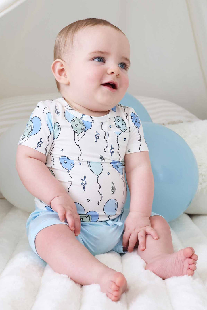 baby boy sitting wearing party time blue shirt and short set