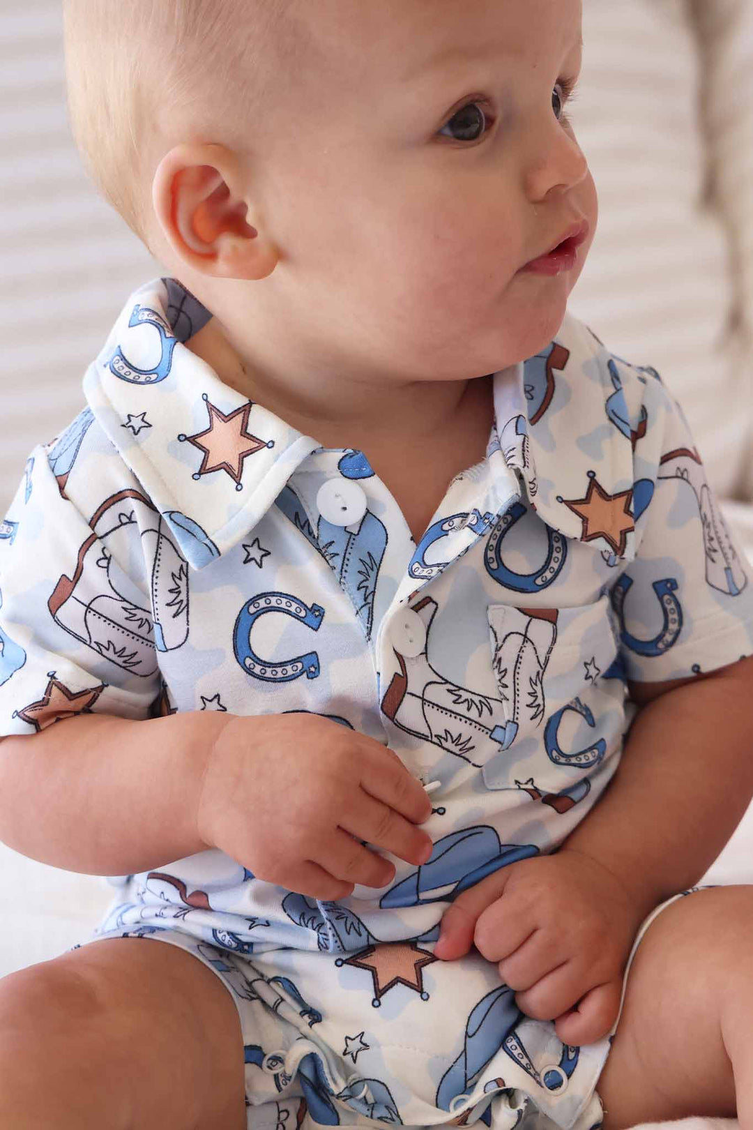 blue rodeo themed short sleeve collared button romper 